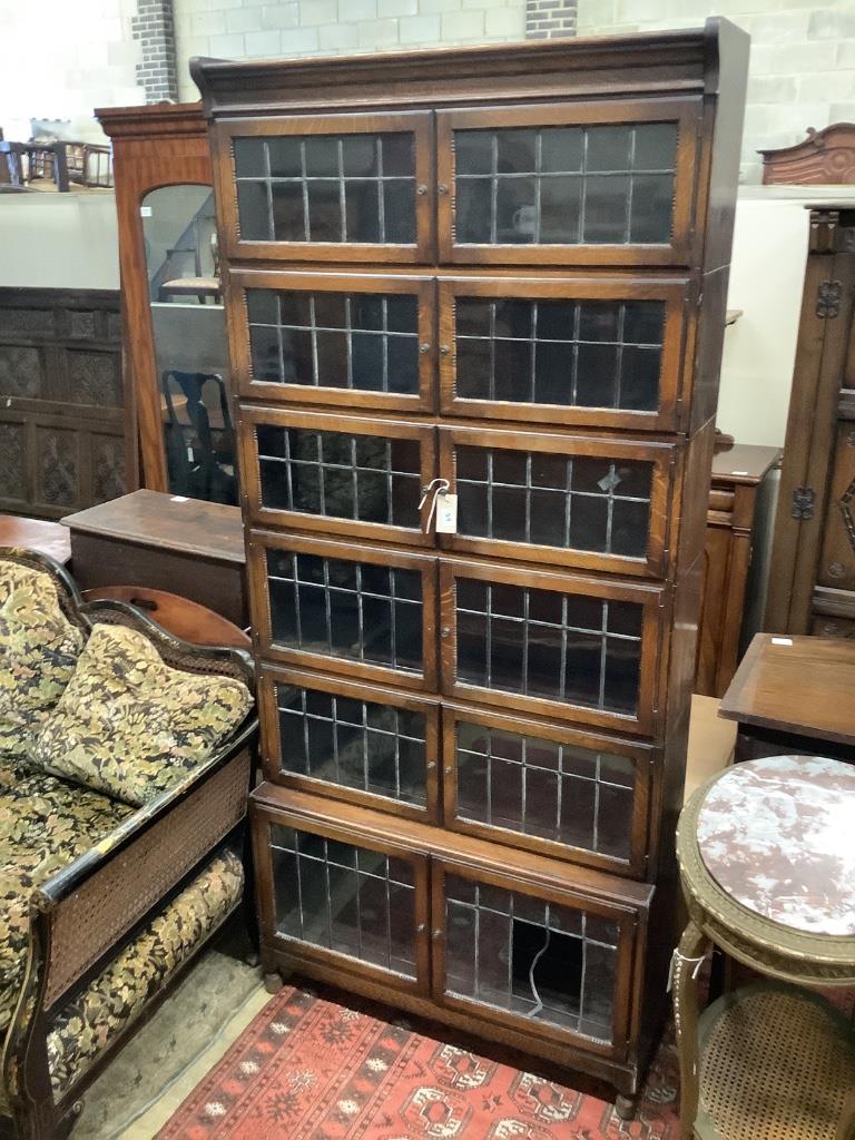 A six tier oak stacking modular bookcase, in the Globe Wernicke style, width 89cm depth 28cm height 198cm